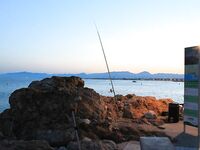 Салоу, пляж Капеланос: местные на закидушки и рыба под скалами